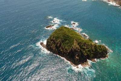 Aerial drone of waves crashing on a rocky island. santa ana, cagayan. philippines.