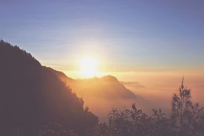 Scenic view of silhouette mountains against sky during sunset