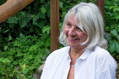 Portrait of woman against plants