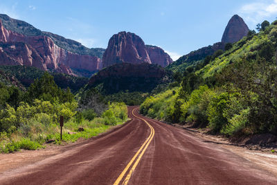 Road amidst mountains against sky