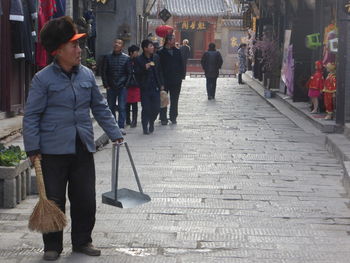 People walking on zebra crossing in city