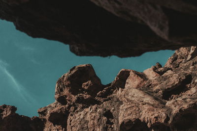 Close-up of rock formation against sky