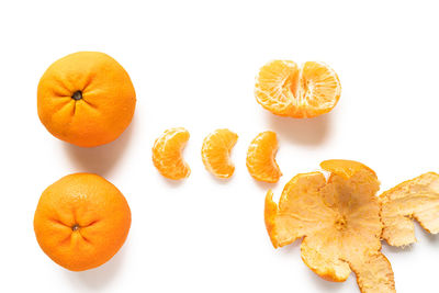 Directly above shot of orange slices over white background