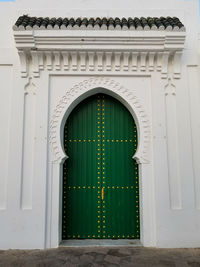 House's green wooden door in the medina of asilah