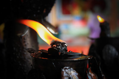 Close-up of burning candles on wood