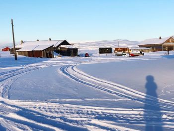 Snow covered houses against sky