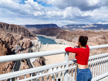 Portrait of woman standing on railing