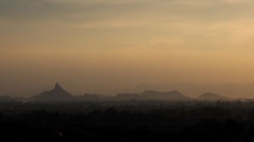 Silhouette of temple against sky during sunset