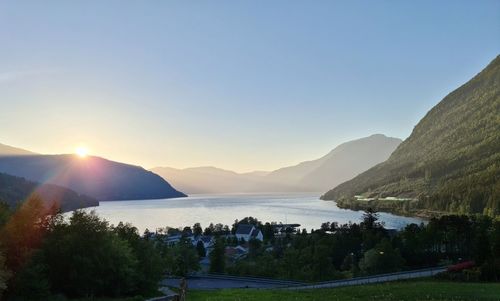 Scenic view of lake and mountains against clear sky