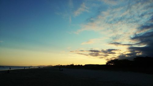 Scenic view of beach against sky during sunset