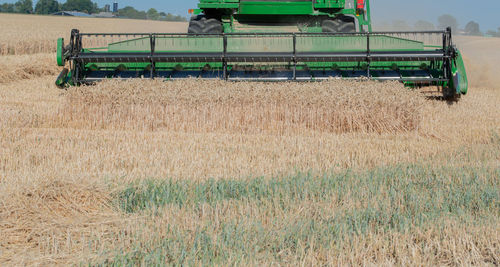 Combine harvester harvesting crops on agricultural field
