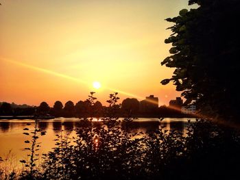 Scenic view of calm lake at sunset