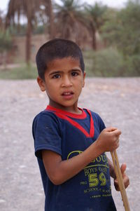 Portrait of boy standing outdoors