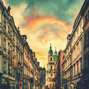 Buildings against cloudy sky at sunset