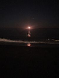 Scenic view of sea against sky at night