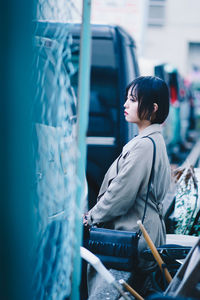 Side view of woman looking at camera
