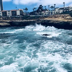 Scenic view of sea and buildings against sky