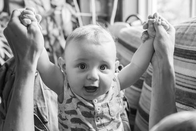 Portrait of cute baby playing with mother