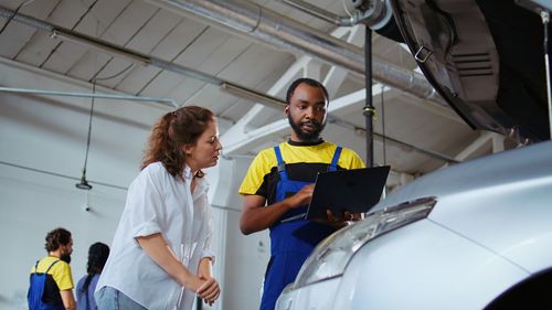 Portrait of female friends standing in factory