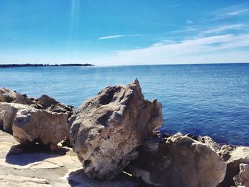Scenic view of sea against blue sky
