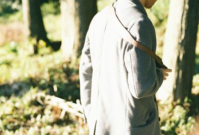 Rear view of man on tree trunk