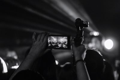 Close-up of cropped hand holding camera