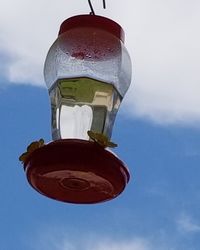 Low angle view of wineglass against sky