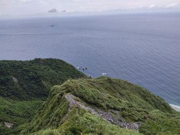 High angle view of sea and mountains against sky