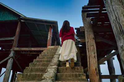 Low angle view of woman standing on staircase