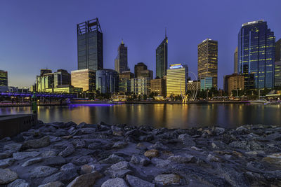 River by modern buildings against clear sky