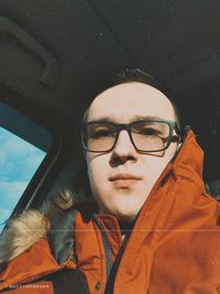 Portrait of young man with reflection in car