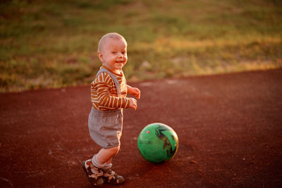 Child playing ball on the playground