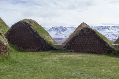 Rear view of the turf houses against the mountains view