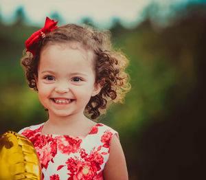 Portrait of smiling young woman holding flower