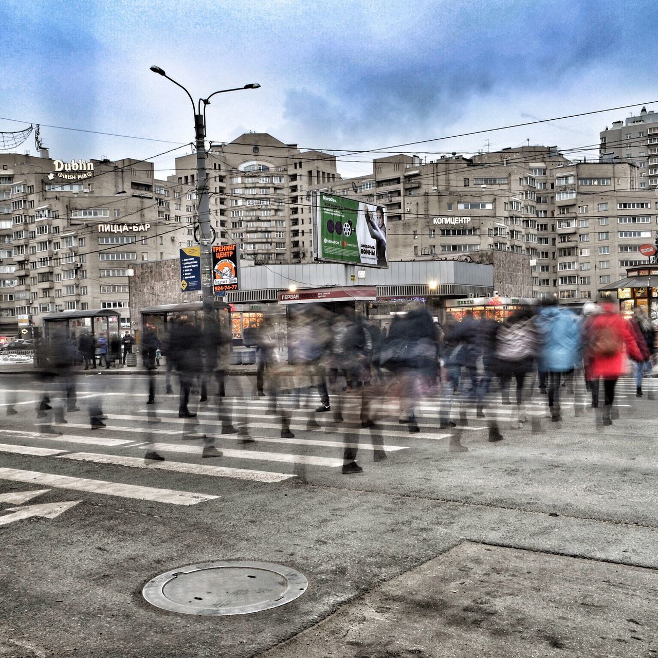 PEOPLE WALKING ON WET STREET IN CITY