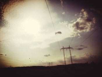 Low angle view of electricity pylon against sky