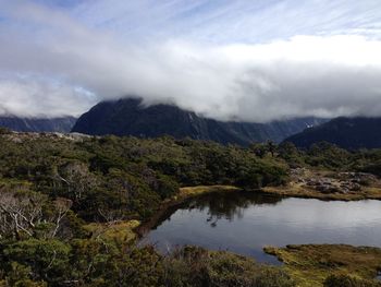 Scenic view of lake and mountains against sky