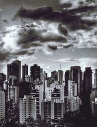 Cityscape against cloudy sky