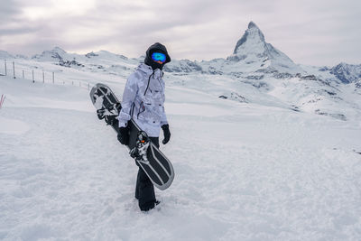 Man skiing on snow covered landscape