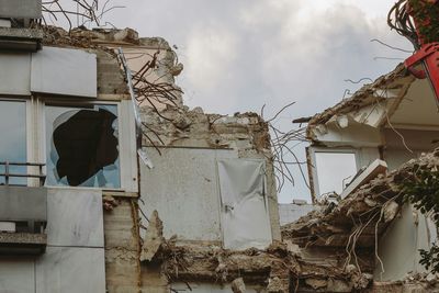 Low angle view of damaged house