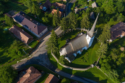 High angle view of church amidst trees and buildings