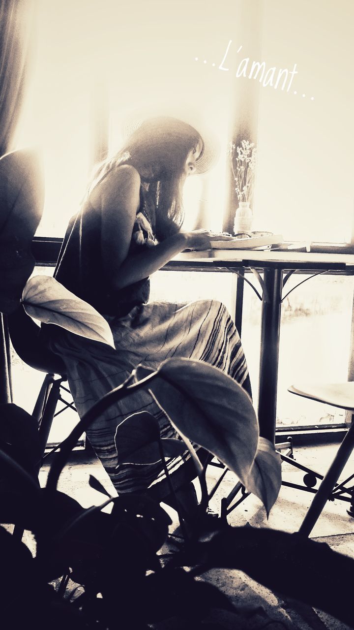 CLOSE-UP OF MAN SITTING IN KITCHEN