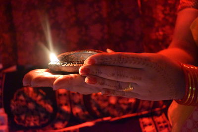 Beautiful fingers of women holding a lamp on the palm 