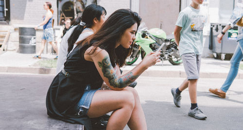 Young couple sitting on road