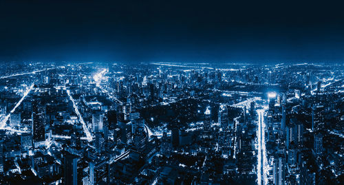 High angle view of illuminated buildings in city at night