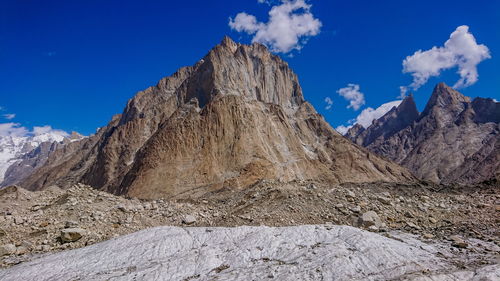 Scenic view of snowcapped mountains against blue sky