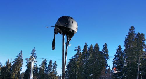 Low angle view of bird flying against clear blue sky