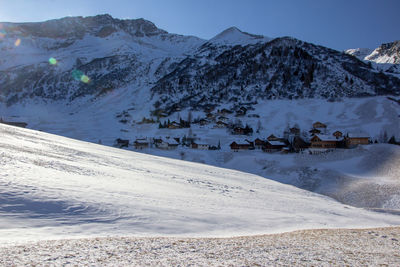 Scenic view of snow covered mountains against sky