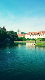 Calm river with buildings in background