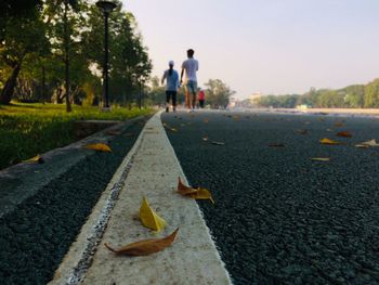 Surface level of man falling on road in city